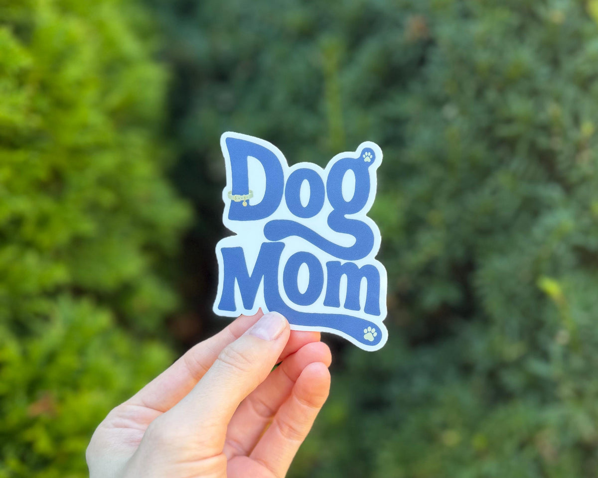 Dog Mom retro sticker held outdoors for the Pet Lovers collection