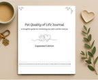 A flat-lay view of a 'Pet Quality of Life Journal' on a beige background, styled with a cup of coffee, a wooden heart, a keychain, and a green leafy sprig.