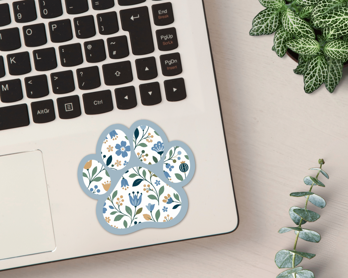Bluebell Floral Paw Print Sticker on a laptop
