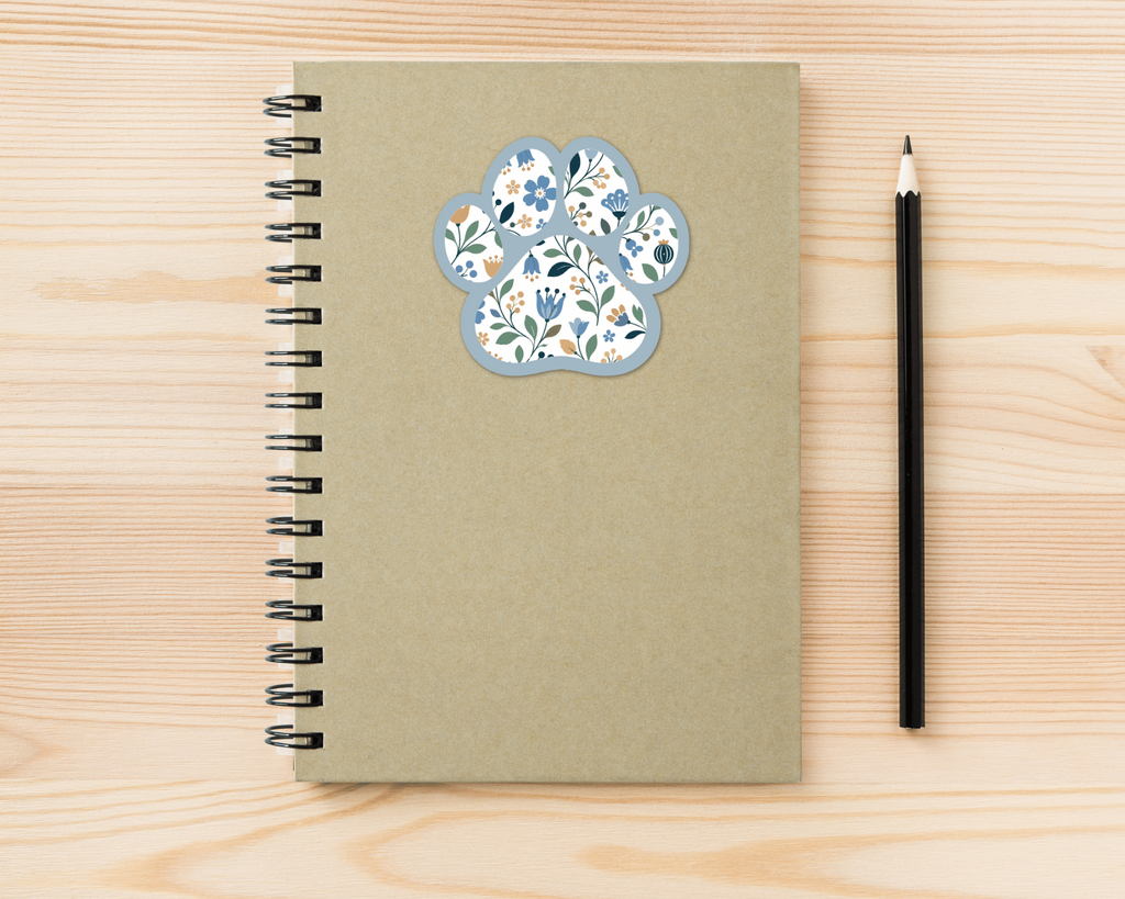 Bluebell Floral Paw Print Sticker on a spiral notebook