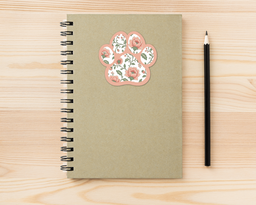 Blush Meadow Floral Paw Print Sticker on a spiral notebook