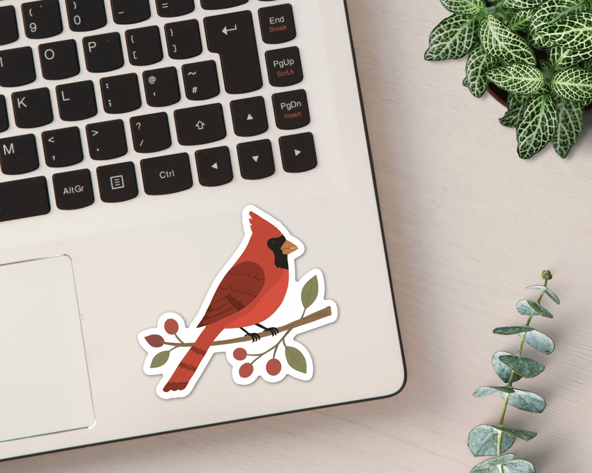 Northern Cardinal vinyl sticker shown on a laptop