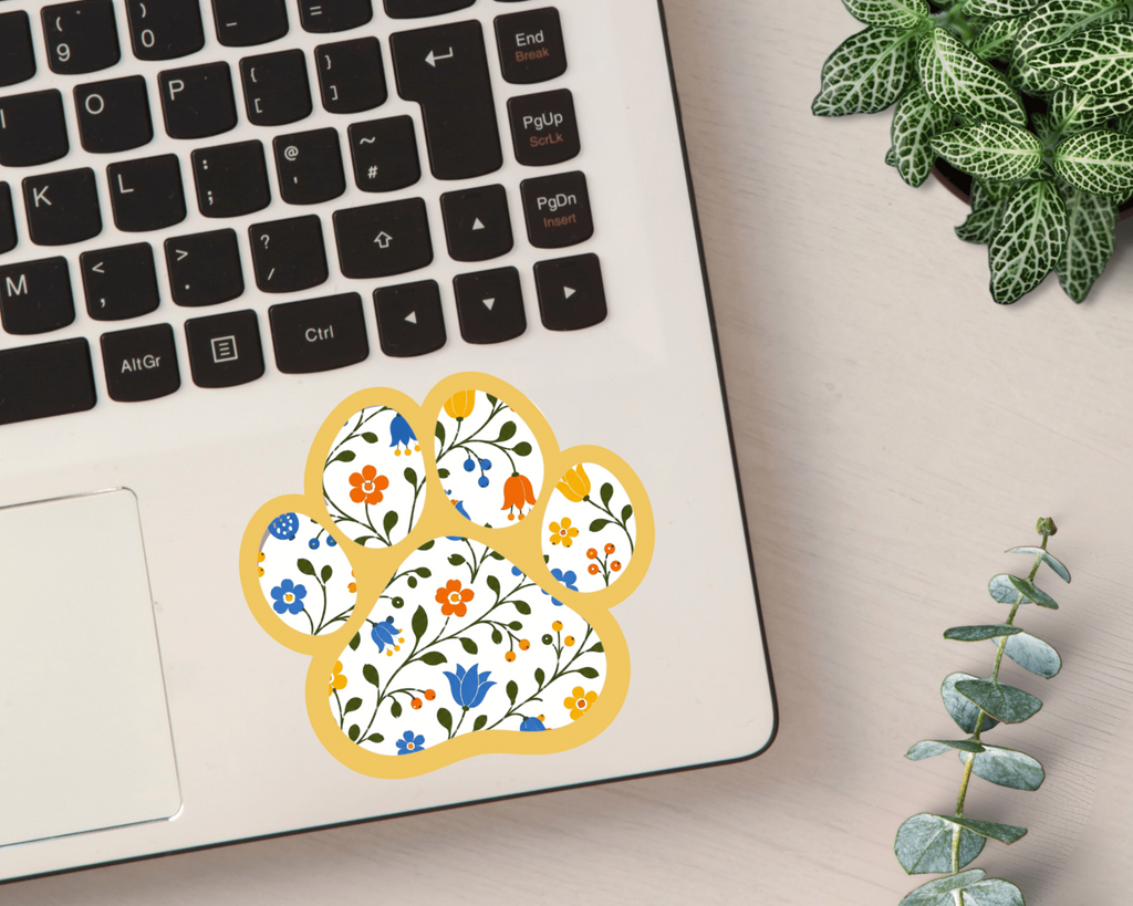 Goldenrod Floral Paw Print Sticker on a laptop