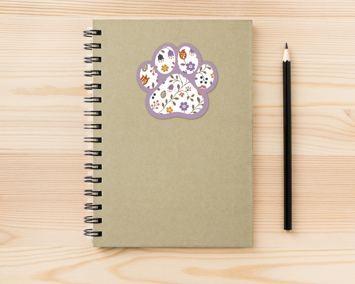 Heather Floral Paw Print Sticker on a spiral notebook