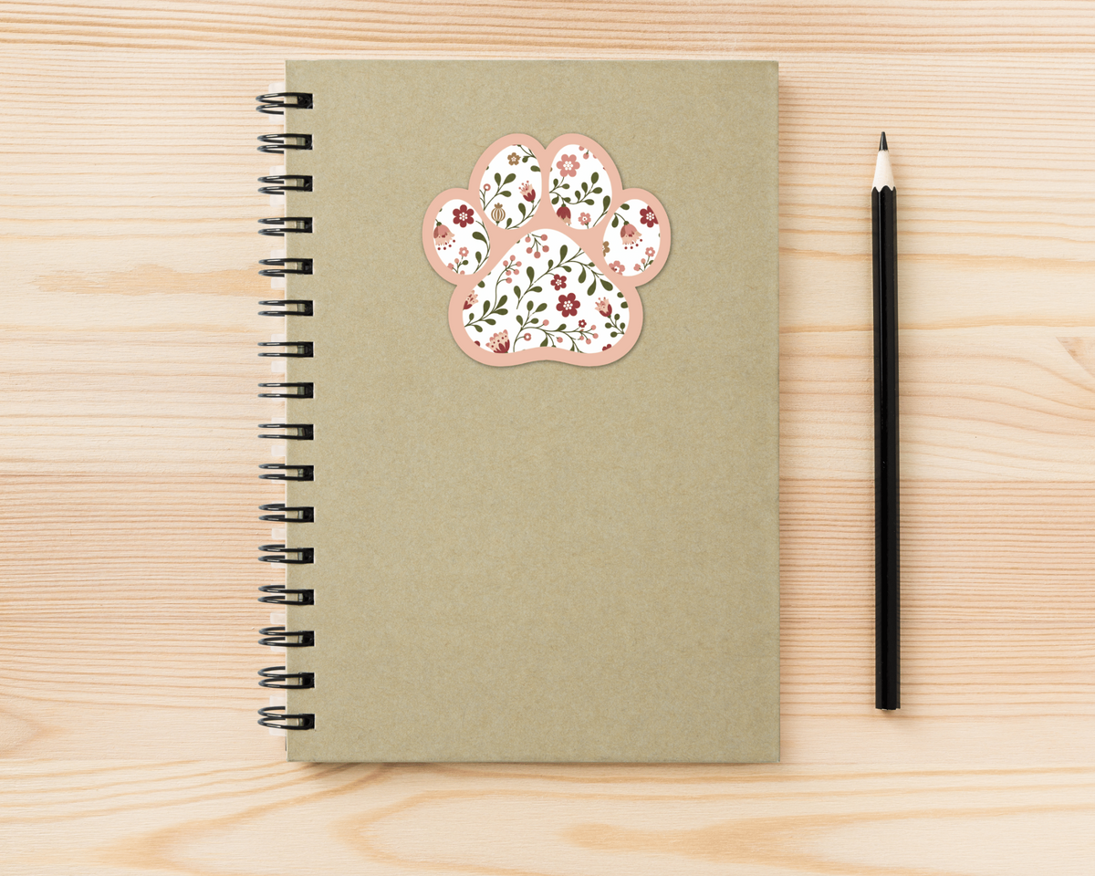 Rose Garden Floral Paw Print Sticker on a spiral notebook