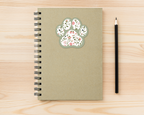 Sage Garden Floral Paw Print Sticker on a spiral notebook