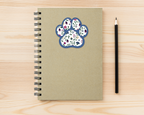 Sapphire Floral Paw Print Sticker on a spiral notebook