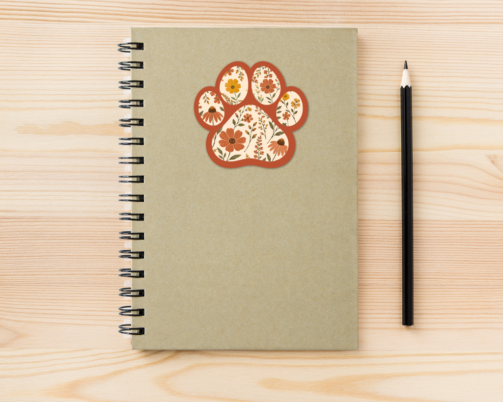 Terracotta Bloom Floral Paw Print Sticker on a spiral notebook